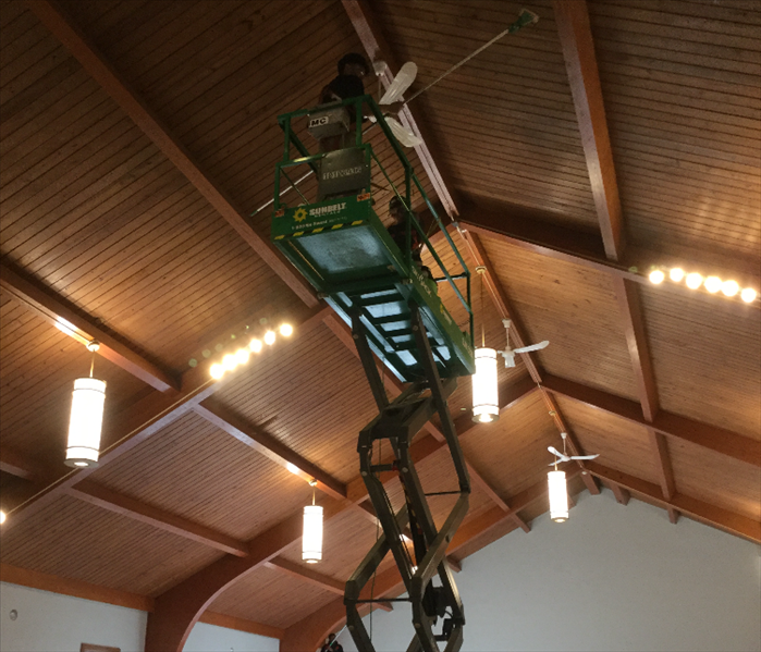 Team members cleaning ceilings.