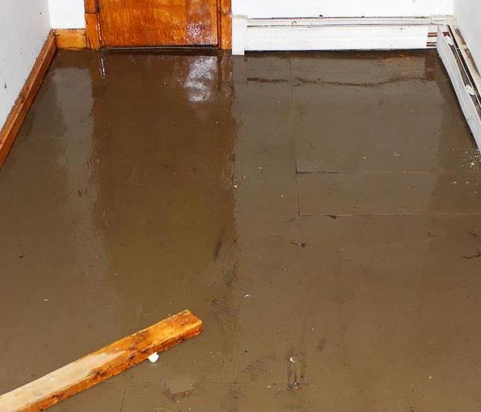 Water on the concrete floor of a room 